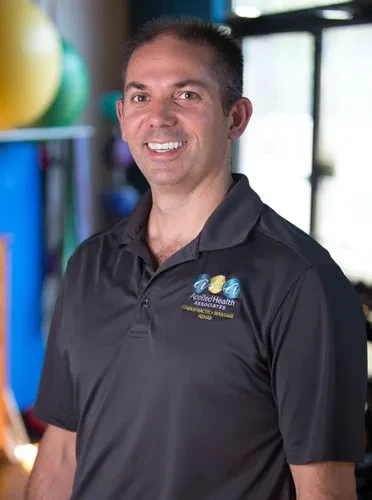 Chiropractor Spokane WA Keith Morehouse Photo of Dr. Keith Morehouse wearing an Applied Health Associates polo and smiling.